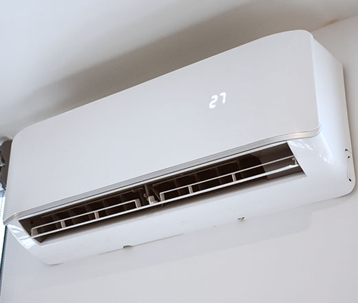 an air conditioning unit mounted to the wall in a home