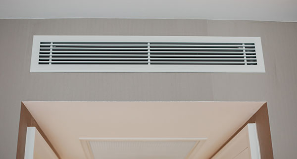 a ducted air conditioning unit high on a wall