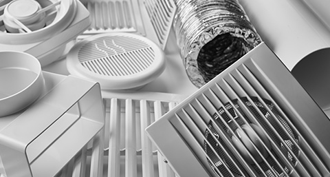 parts of an air conditioning system sitting on a white surface